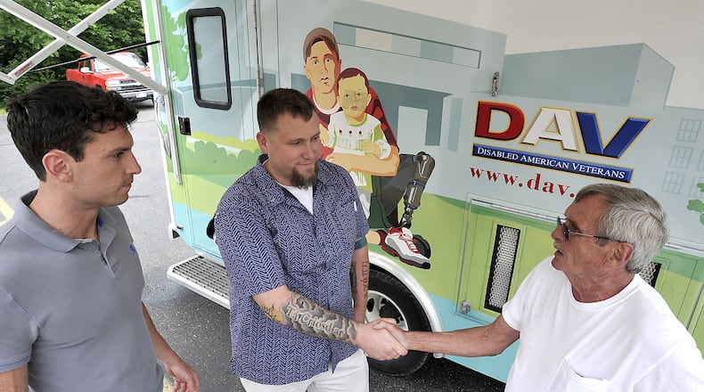 Veteran Mick Sullivan, right, meets with Josh Rondini, left, and Matt Persons outside the Disabled American Veterans’ Mobile Service Office on Monday, June 24, 2013, during the mobile office’s stop at the Clark County DAV on Mechanicsburg Road. Bill Lackey/Staff