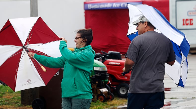 Jody and Stephen Harner battle the effects from Hurricane Helene , Friday, Sept. 27, 2024 at the 53rd Aunnual Old Timers Festival at the Greene County Fairgrounds and Expo Center. MARSHALL GORBY\STAFF