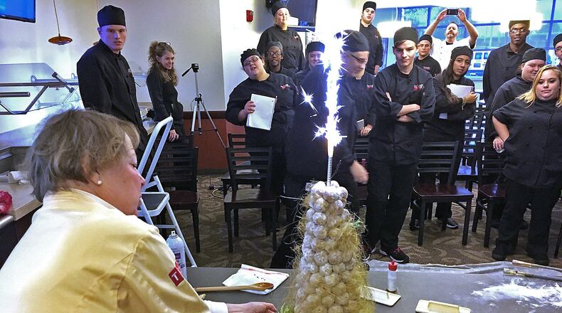 Sparks shoot out of the top of a dessert prepared by renowned pastry chef Jan Kish, from Columbus, as she holds a cooking presentation for students in the Culinary Arts program at the CTC Tuesday. Bill Lackey/Staff