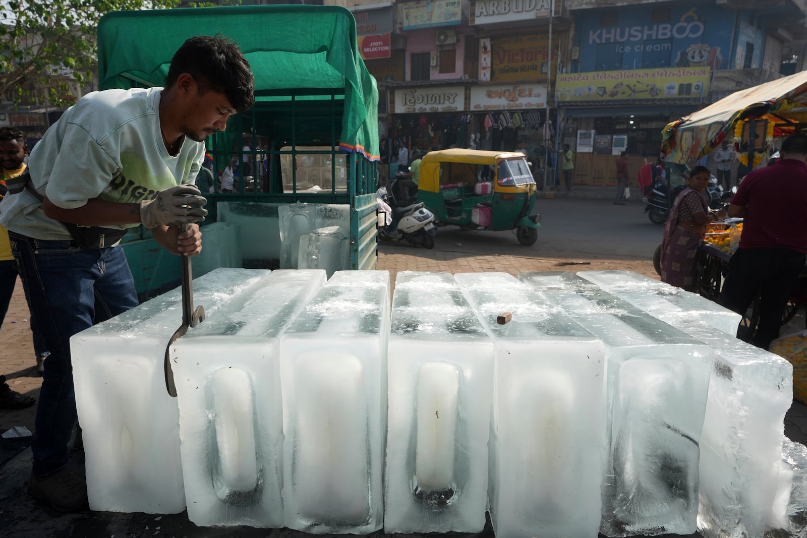 A man arranges ice blocks to sell at his stall in Ahmedabad, India, Wednesday, April 2, 2025. (AP Photo/Ajit Solanki)