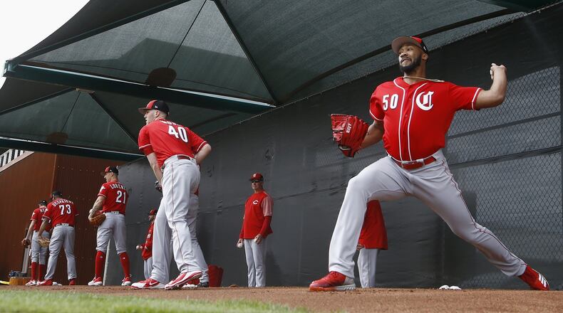 Cincinnati Reds pitchers Amir Garrett (50), Alex Wood (40), Michael Lorenzen (21) and Odrisamer Despaigne (73) join others as they pitch during workouts at the Reds spring training baseball facility, Wednesday, Feb. 13, 2019, in Goodyear, Ariz. (AP Photo/Ross D. Franklin)