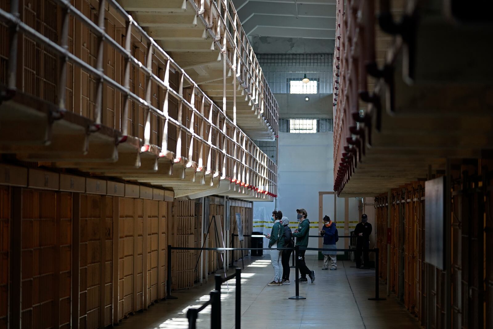 FILE - People tour the main cell house on Alcatraz Island in San Francisco, March 15, 2021, as the historic island prison was reopened to visitors after being closed since Dec. 2020, because of the coronavirus threat. (AP Photo/Eric Risberg, File)