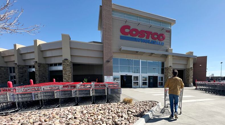 FILE - A lone shopper pushes a cart toward the entrance of a Costco warehouse, March 13, 2025, in Sheridan, Colo. (AP Photo/David Zalubowski, File)
