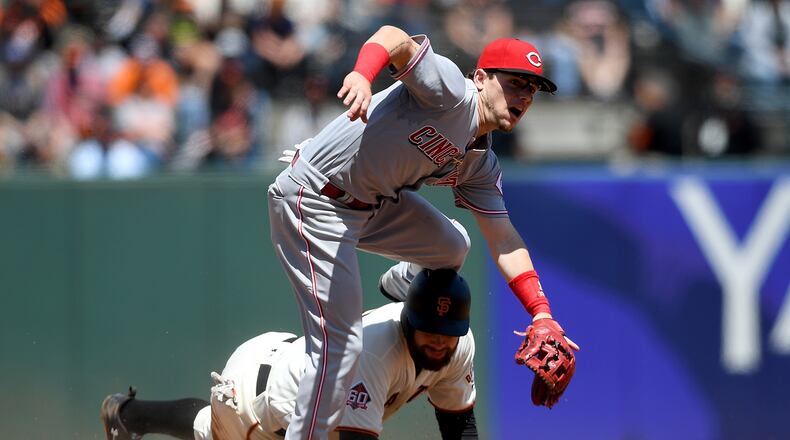 SAN FRANCISCO, CA - MAY 16: Scooter Gennett #3 of the Cincinnati Reds leaps over Brandon Belt #9 of the San Francisco Giants after getting his throw off to complete the douple play in the bottom of the fifth inning at AT&T Park on May 16, 2018 in San Francisco, California. (Photo by Thearon W. Henderson/Getty Images)