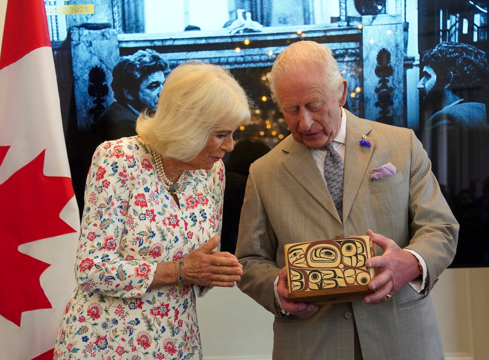 Britain's King Charles and Queen Camilla look at the Key to Canada House which was presented to the King by High Commissioner for Canada, Ralph Goodale, during a visit to Canada House to mark 100 years since it opened, in London, Tuesday, May 20, 2025. (Arthur Edwards/Pool via AP)