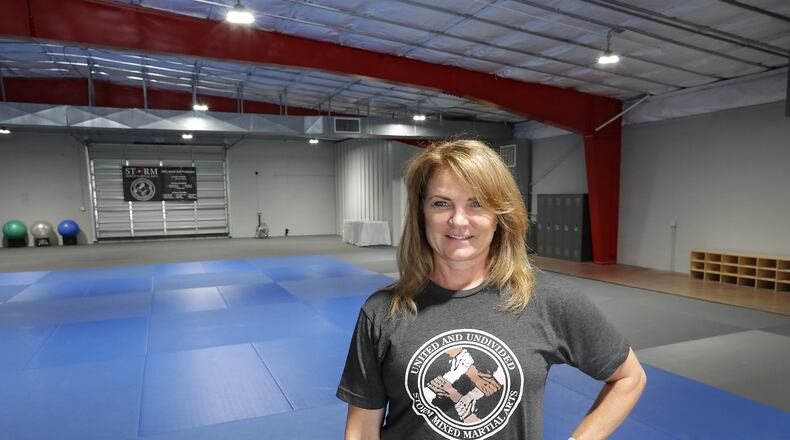 Sandy Bise, owner of Storm Mixed Martial Arts, in their new training center on North Thompson Avenue Thursday. BILL LACKEY/STAFF