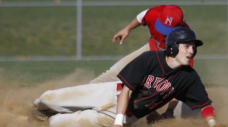 Tony Evans (14) of Tecumseh slides in to second base while defended by Justin Philpot (3) of Northwestern during Wednesday’s baseball game at Tecumseh on March 28, 2012. Photo by Barbara J. Perenic