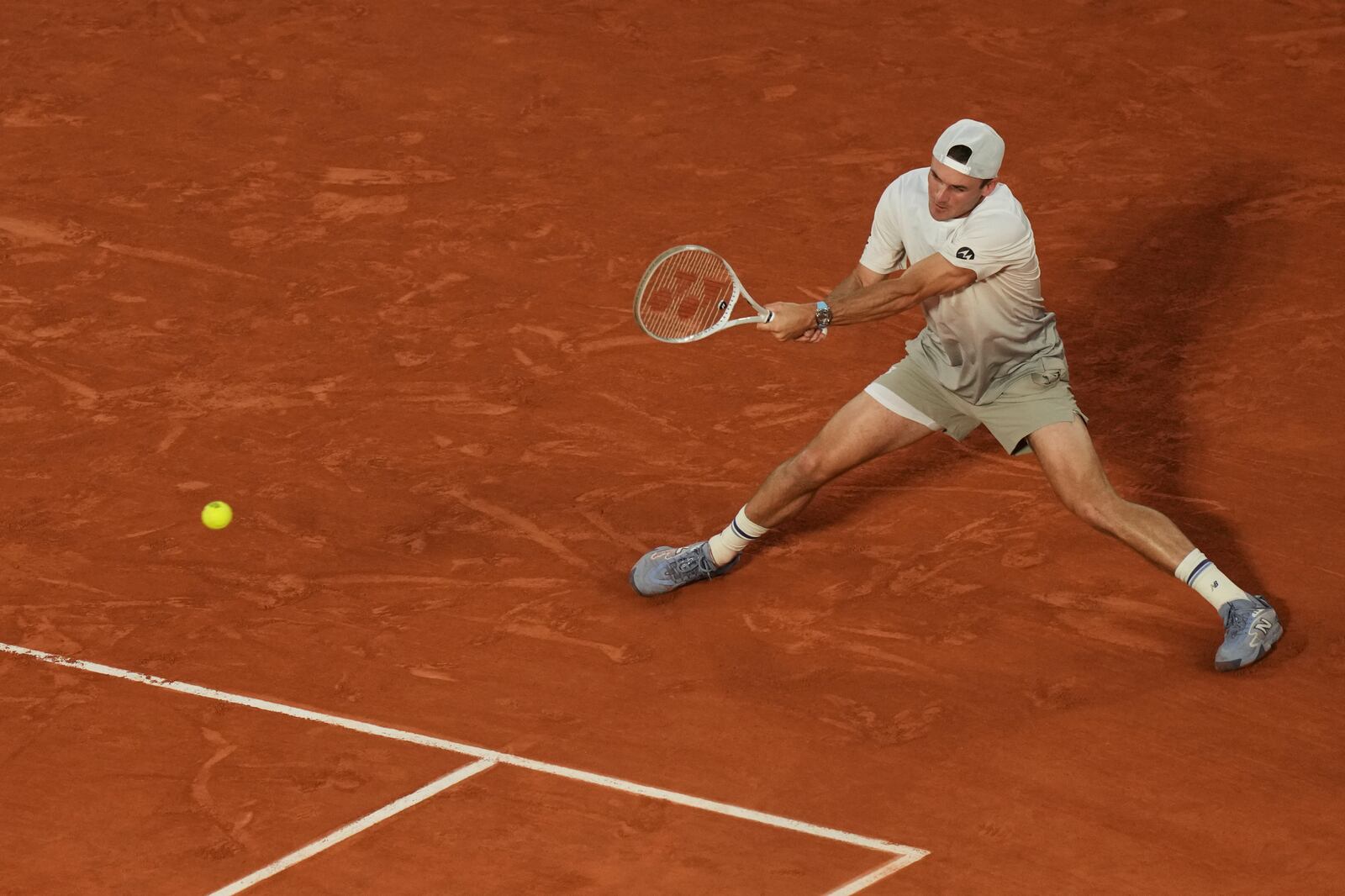Tommy Paul of the U.S. plays a shot against Spain's Carlos Alcaraz during their quarterfinal match of the French Tennis Open at the Roland-Garros stadium in Paris, Tuesday, June 3, 2025. (AP Photo/Thibault Camus)