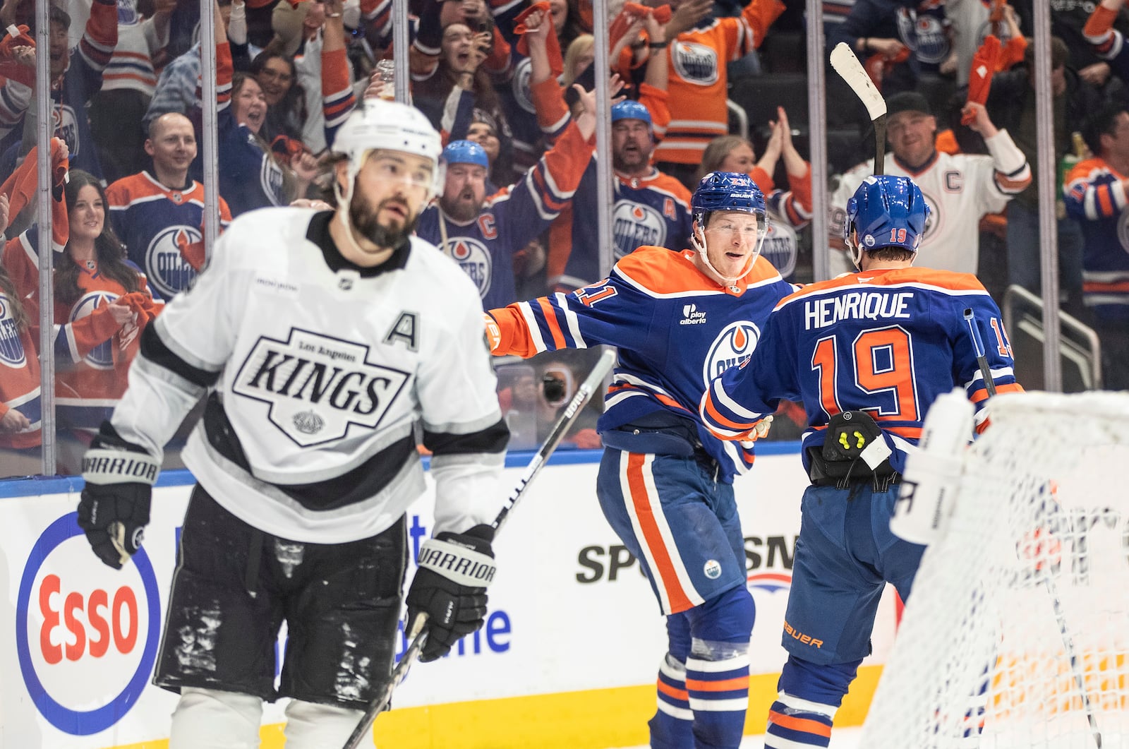 Edmonton Oilers' Trent Frederic (21) and Adam Henrique (19) celebrate a goal as Los Angeles Kings' Drew Doughty (8) skates past during the second period of an NHL hockey game in Edmonton, Alberta, Thursday, May 1, 2025. (Jason Franson/The Canadian Press via AP)