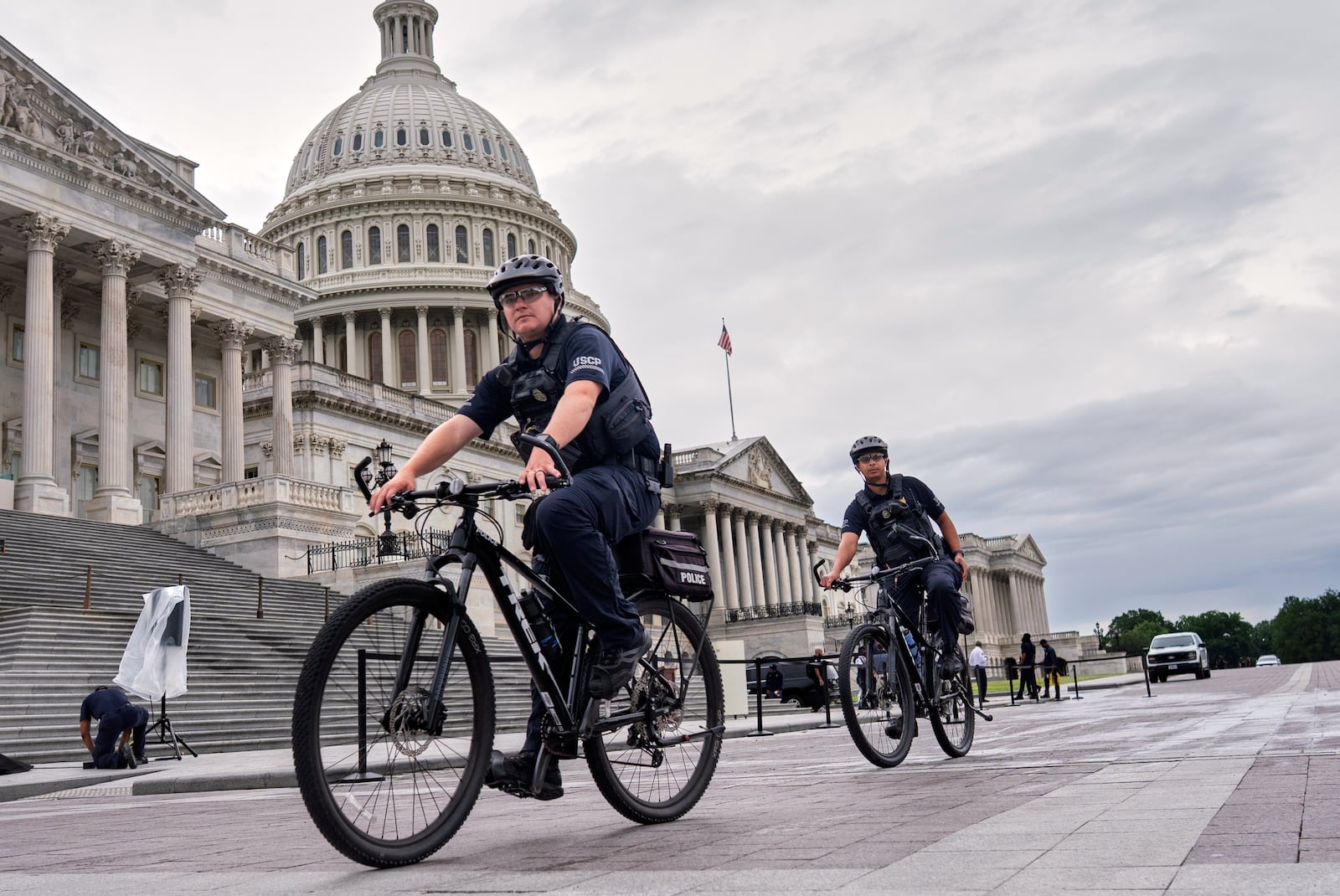 U.S. Capitol Police patrol the plaza as House Republicans work inside to pass President Donald Trump's signature bill of tax breaks and spending cuts by a self-imposed Fourth of July deadline, at the Capitol in Washington, Wednesday, July 2, 2025. (AP Photo/J. Scott Applewhite)