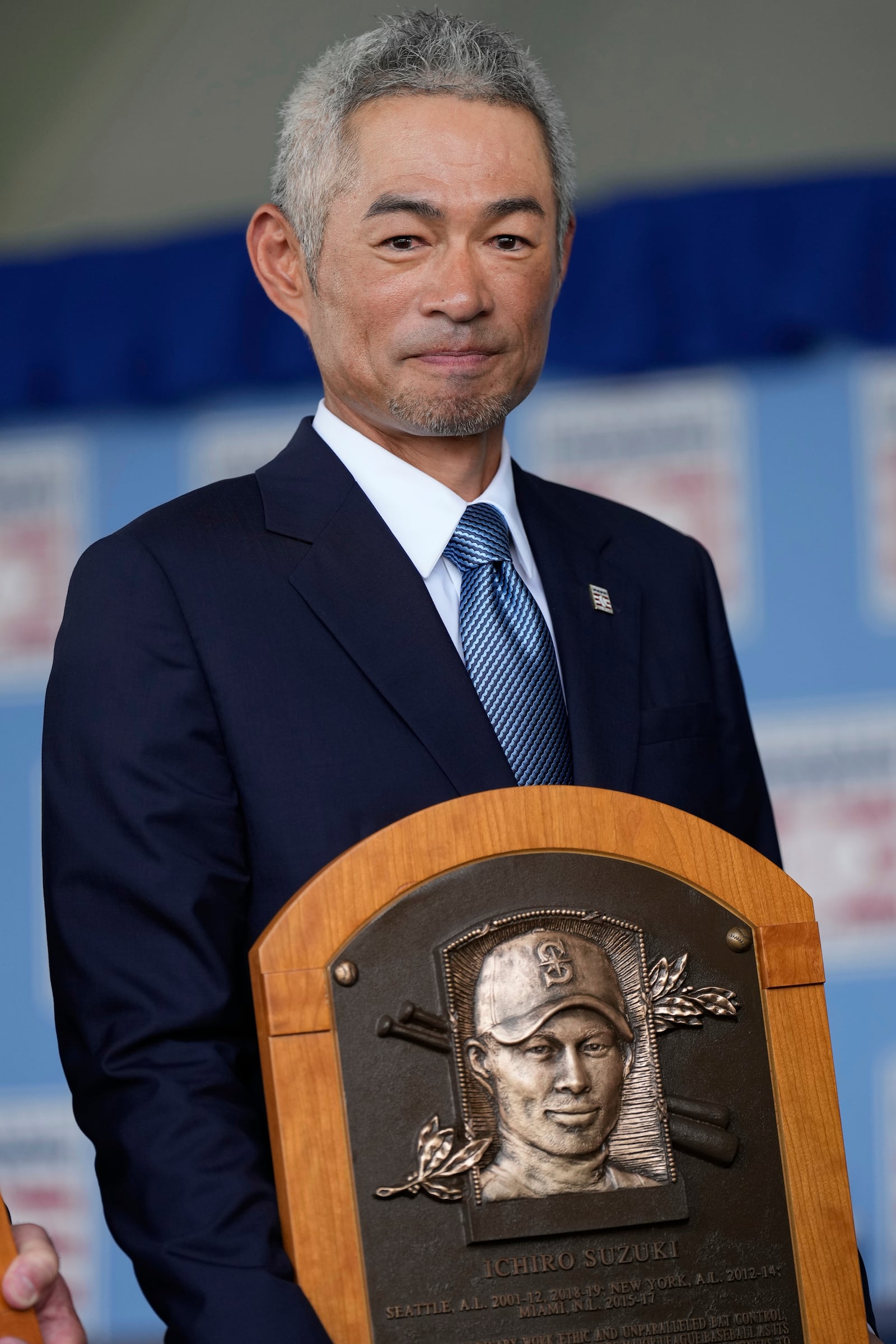 Baseball Hall of Fame inductee Ichiro Suzuki poses for a photo with his plaque after the National Baseball Hall of Fame induction ceremony in Cooperstown, N.Y., Sunday, July 27, 2025. (AP Photo/Seth Wenig)