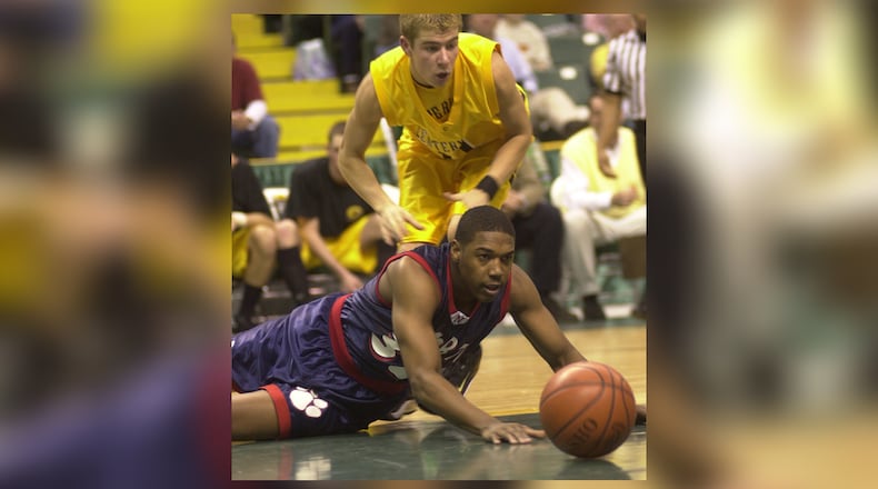 Springfield North's Adam Ellis (32) and Centerville's Matt Beck (11) scramble after a loose ball during their tournament game Monday, March 6, 2000 at Wright State's Nutter Center. BILL LACKEY / STAFF PHOTO