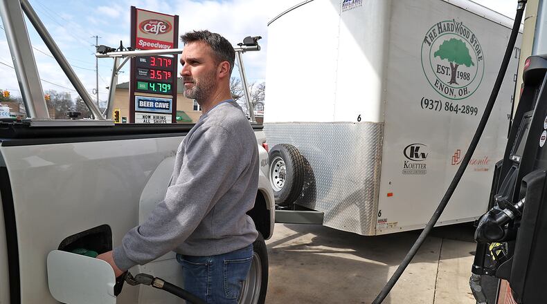 Rob Fletcher pumps gas at the Speedway station in Enon Wednesday. Gas prices have slowly been dropping in the area over the last few days. BILL LACKEY/STAFF