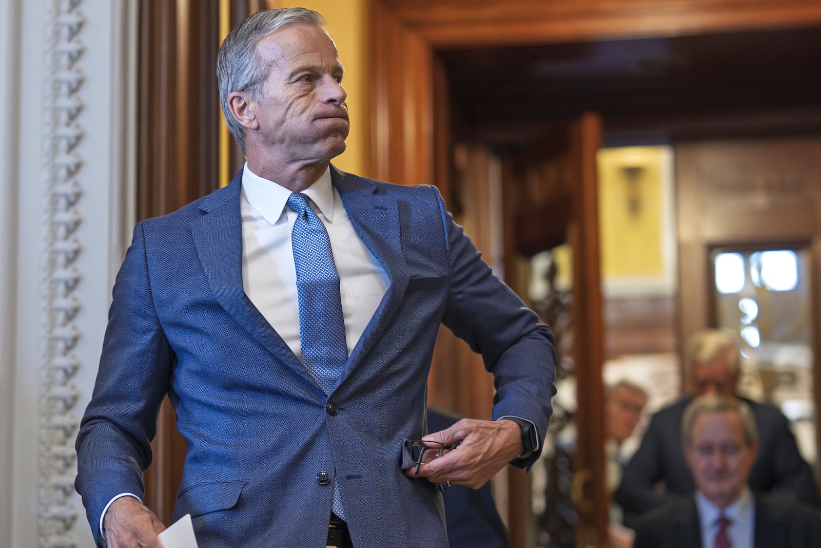 Senate Majority Leader John Thune, R-S.D., emerges from the chamber just after passage of the budget reconciliation package of President Donald Trump's signature bill of big tax breaks and spending cuts, at the Capitol in Washington, Tuesday, July 1, 2025. (AP Photo/J. Scott Applewhite)