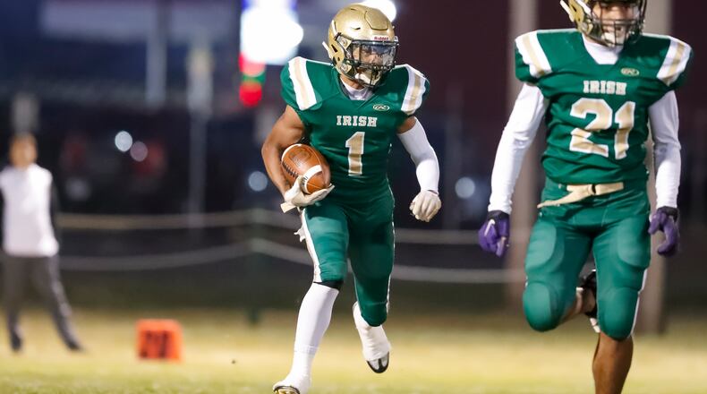 Catholic Central High School junior running back Daniel Kamara carries the ball during their game against St. Bernard Elmwood Place on Friday night at Hallinean Field. The Irish won 33-0. CONTRIBUTED PHOTO BY MICHAEL COOPER