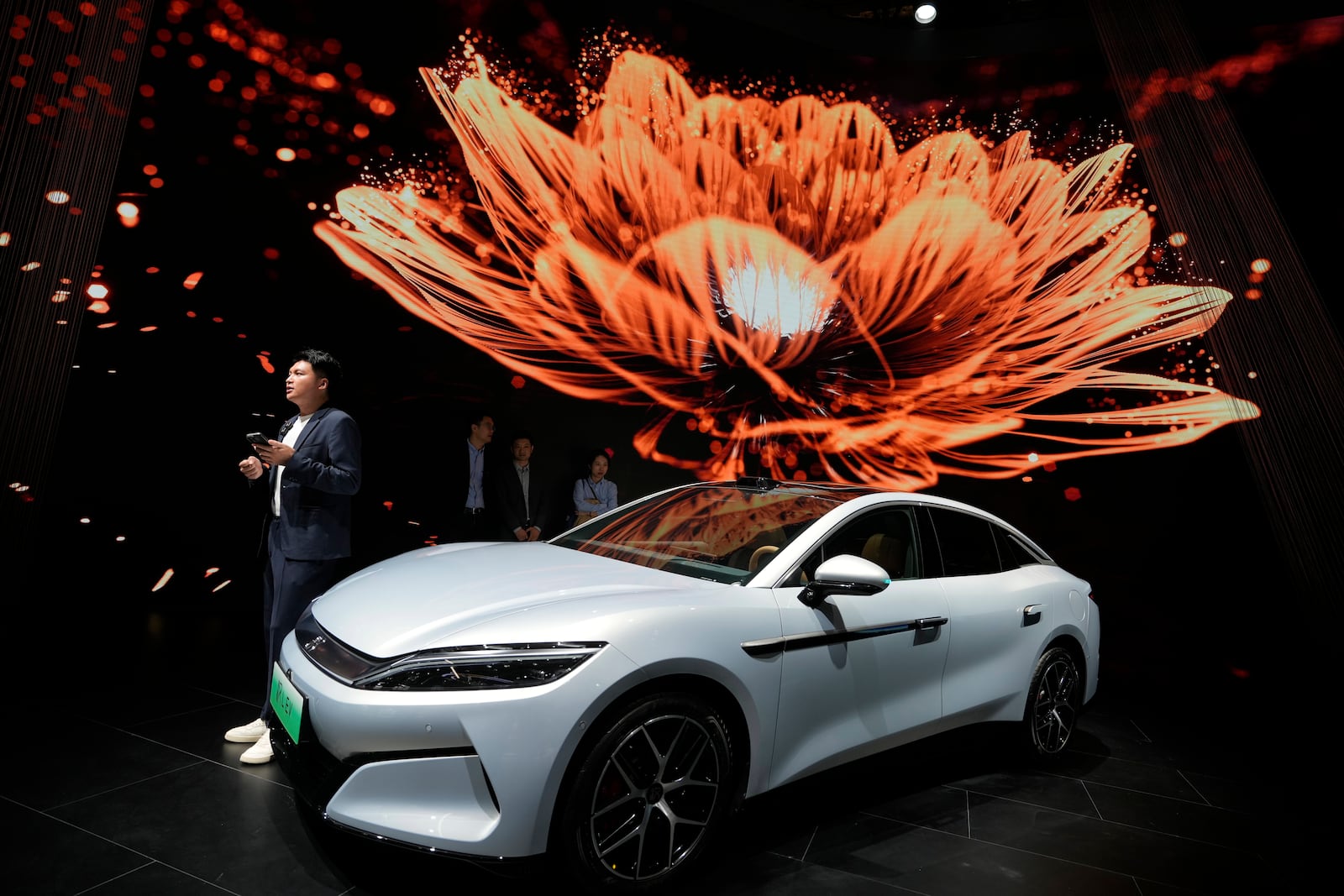 FILE - A man stands near the Han L EV model from BYD during the Shanghai auto show, April 23, 2025. (AP Photo/Ng Han Guan, File)
