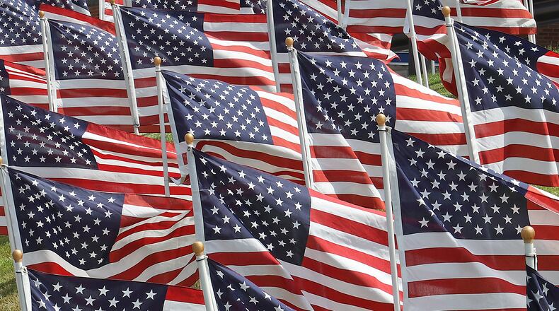 Dozens of American flags wave in the breeze as part of the Field of Honor in front of Mercy Health-Urbana Hospital Monday. The flags were on display all weekend in honor of health care workers and first responders. BILL LACKEY/STAFF
