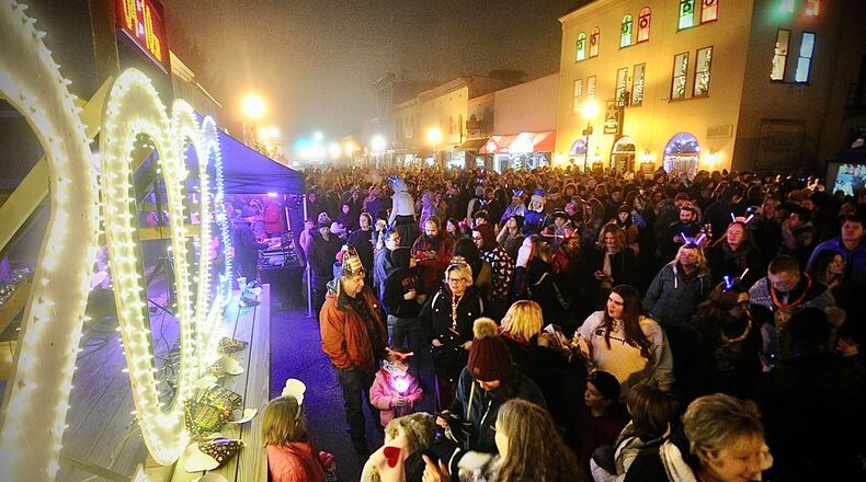 Hundreds of people watch the ball drop and count down the new year in New Carlisle on Saturday. MARSHALL GORBY \STAFF