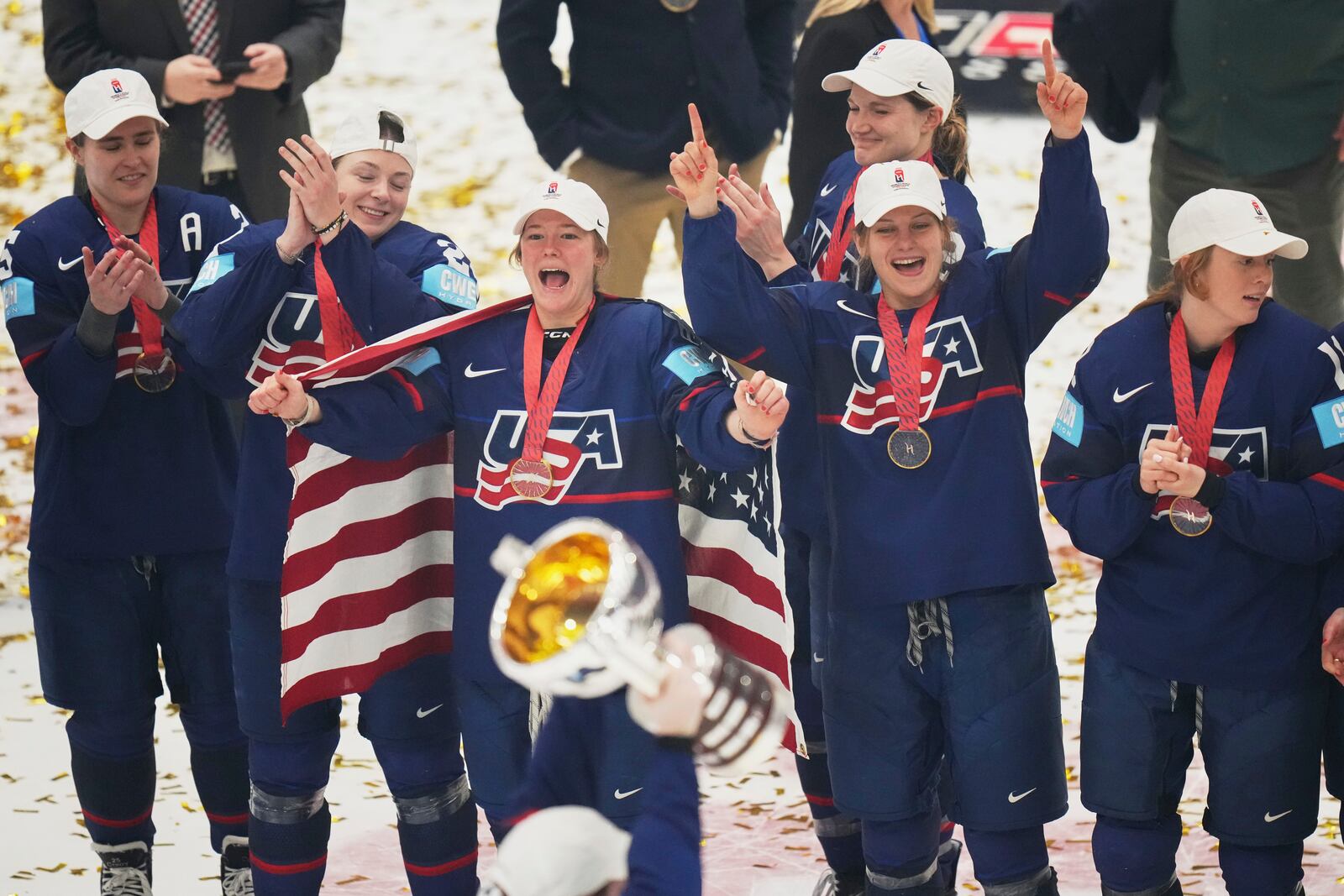 United states players celebrate with a trophy after the gold medal match between Canada and United States at the Women's Ice Hockey Championships in Ceske Budejovice, Czech Republic, Sunday, April 20, 2025. (AP Photo/Petr David Josek)