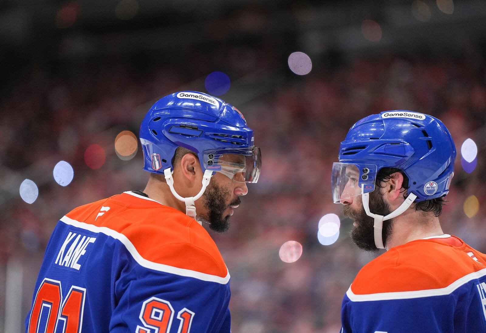 Edmonton Oilers' Evander Kane, left, talks to Adam Henrique before a faceoff during third period of Game 5 of the NHL Stanley Cup final against the Florida Panthers, in Edmonton, Alberta, Saturday, June 14, 2025. (Darryl Dyck/The Canadian Press via AP)