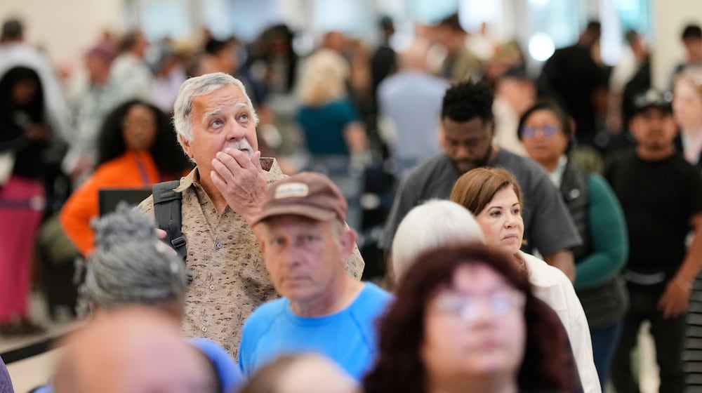 Passengers wait in a security checkpoint line at George Bush Intercontinental Airport, Wednesday, March 25, 2026, in Houston. (AP Photo/David J. Phillip)