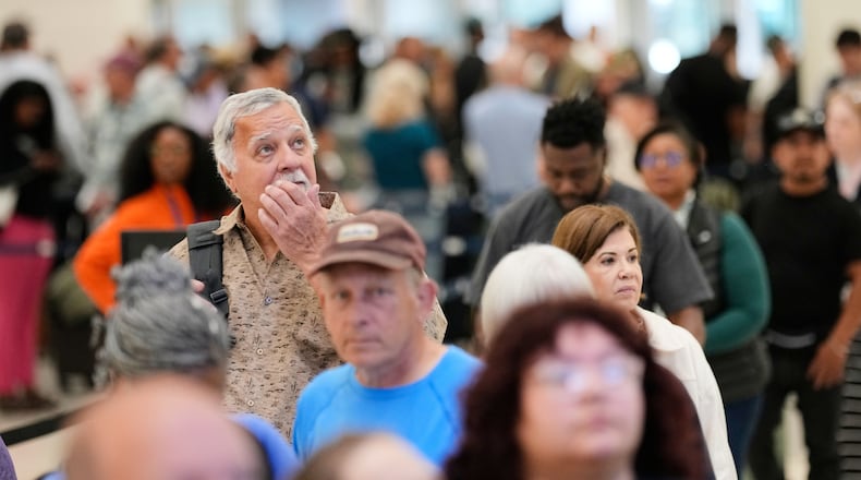 Passengers wait in a security checkpoint line at George Bush Intercontinental Airport, Wednesday, March 25, 2026, in Houston. (AP Photo/David J. Phillip)