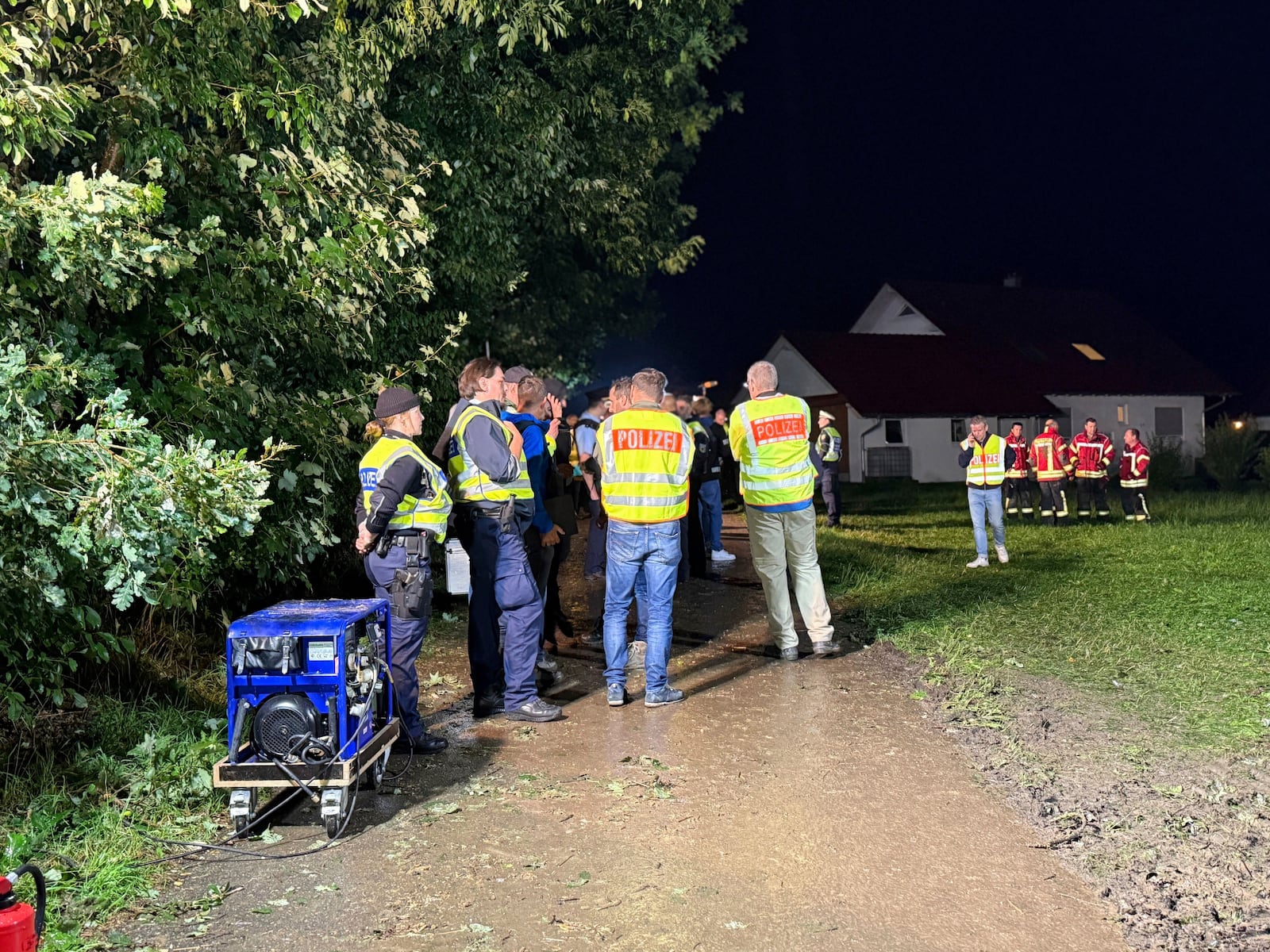 Emergency services stand near the derailed regional passenger train on a section of track near Riedlingen, Germany, Sunday, July 27, 2025. (Nico Pointner/dpa via AP)