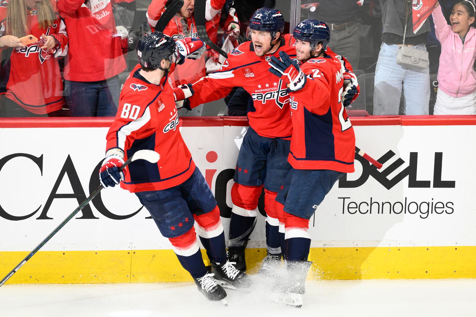 Washington Capitals right wing Brandon Duhaime (22) celebrates his empty net goal with left wing Pierre-Luc Dubois (80) and Connor McMichael, right, in the third period of Game 5 of a first-round NHL hockey playoff series against the Montreal Canadiens Wednesday, April 30, 2025, in Washington. (AP Photo/Nick Wass)