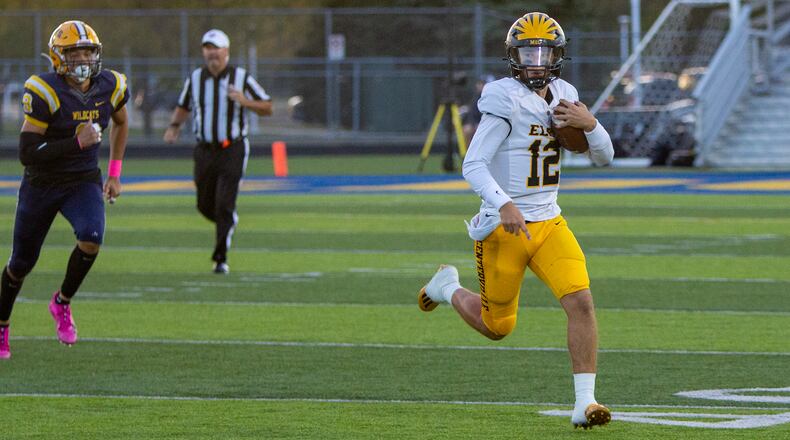 Centerville quarterback Drake Wells runs for yardage during Friday night's game at Springfield. Jeff Gilbert/CONTRIBUTED
