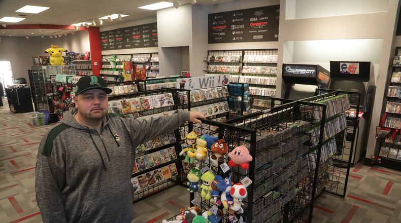 Kenneth Seeling, owner of Champion City Video Games, in the new location Wednesday. Champion City has been closed for the past week but reopens in a bigger location next to their original location on Saturday. BILL LACKEY/STAFF