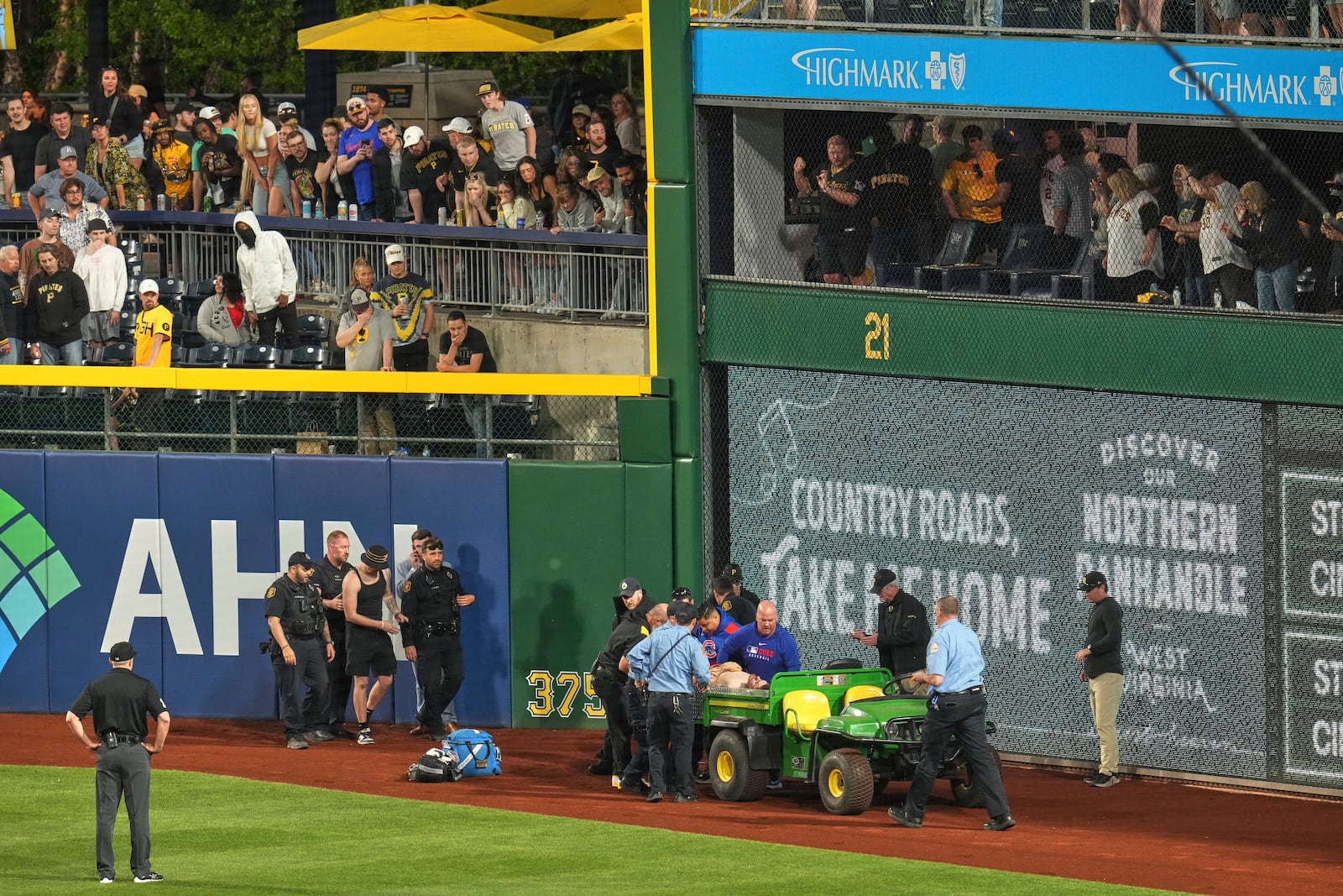 A fan is carted off the field at PNC Park after falling out of the stands during the seventh inning of a baseball game between the Pittsburgh Pirates and the Chicago Cubs in Pittsburgh, Wednesday, April 30, 2025. (AP Photo/Gene J. Puskar)