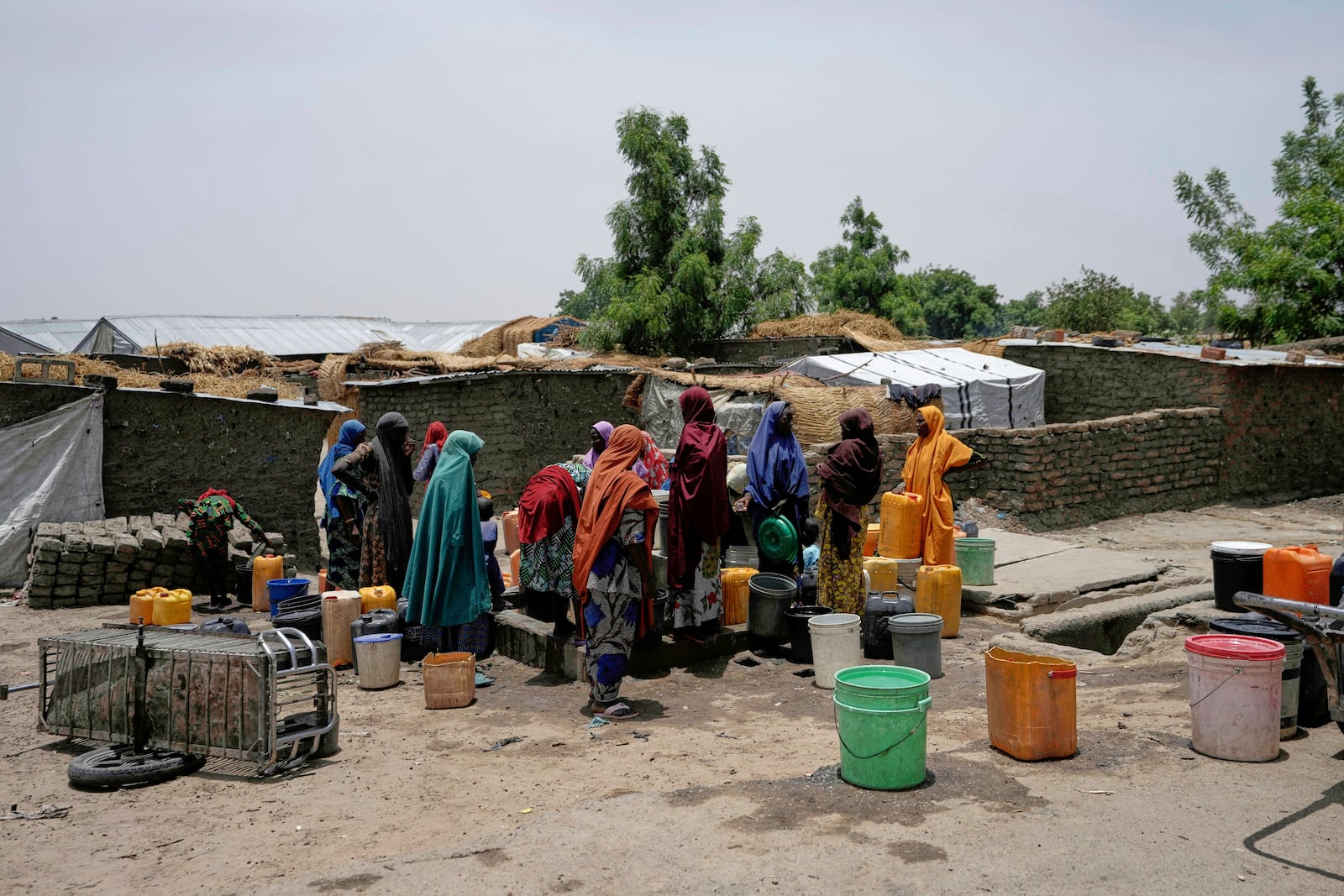FILE- Women displaced from Boko Haram attacks fetch water from a borehole in Dikwa, north east Nigeria, April 29, 2025. (AP Photo/Sunday Alamba, File)