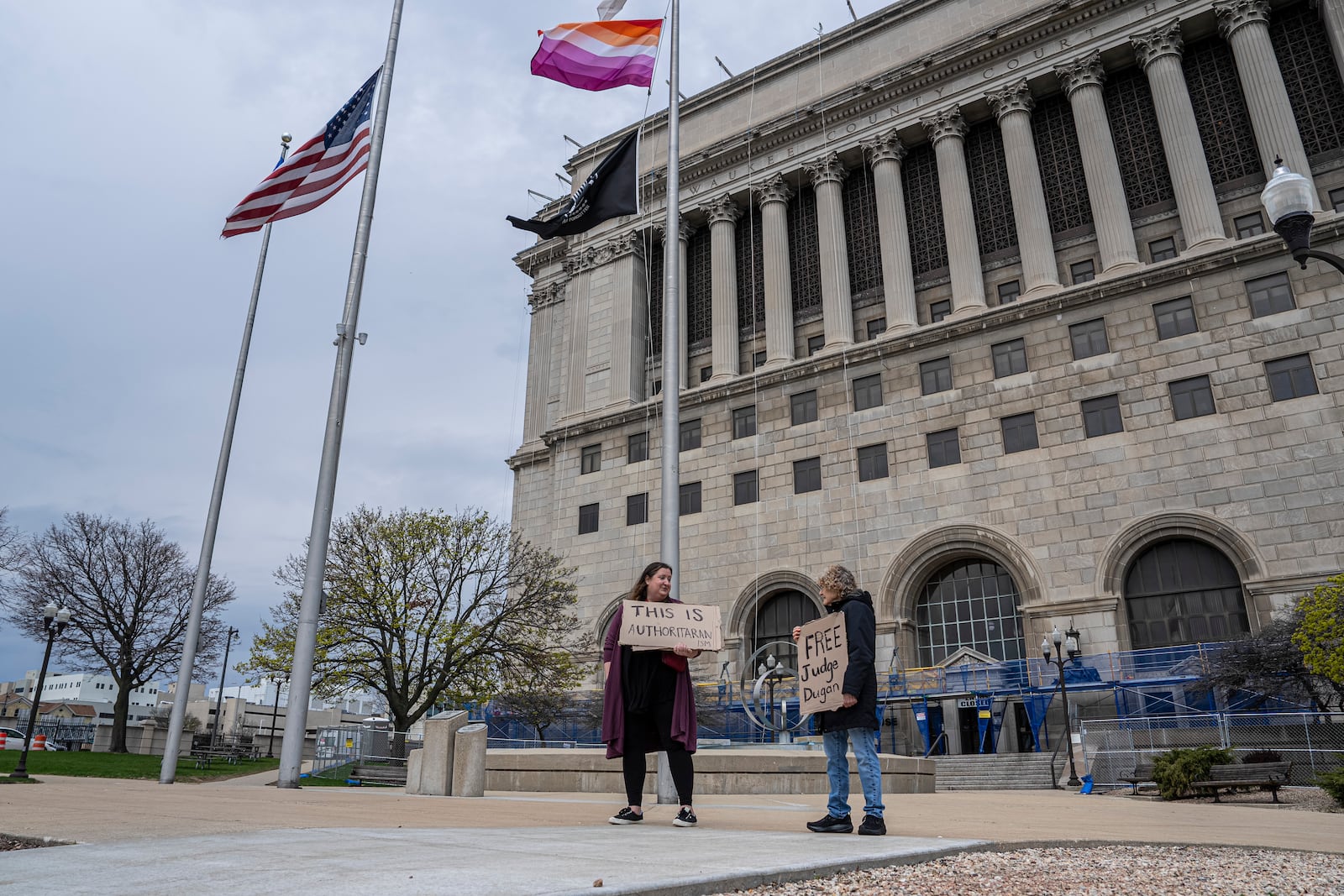 FILE - Protesters stand outside of the Milwaukee County Courthouse, April 25, 2025, in Milwaukee. (AP Photo/Andy Manis, File)