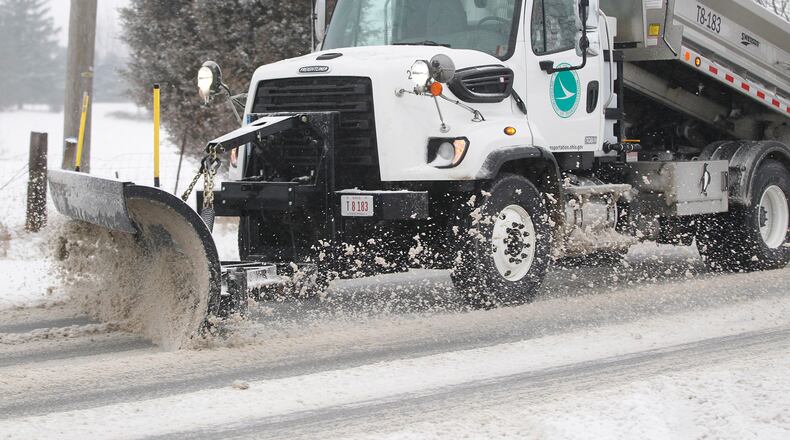 An ODOT truck plows and salts U.S. 68 south of Xenia after another winter storm blew through the area early Wednesday morning. TY GREENLEES / STAFF