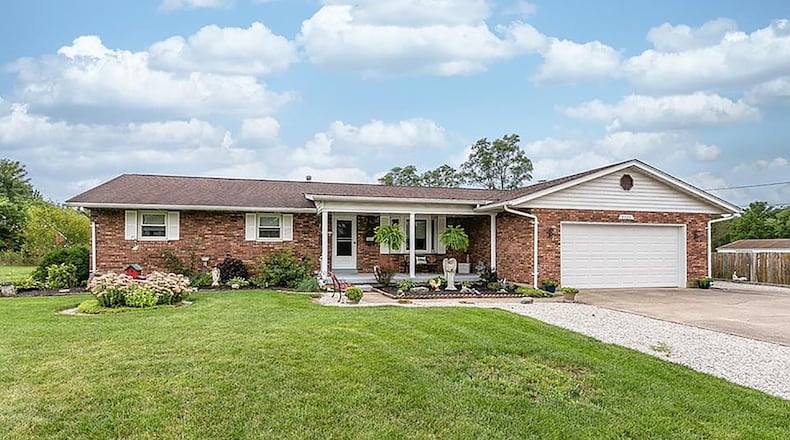 The front of the all-brick ranch has a concrete driveway and two-car attached garage, covered front porch with concrete painted floor and heavy landscaping. Contributed photos