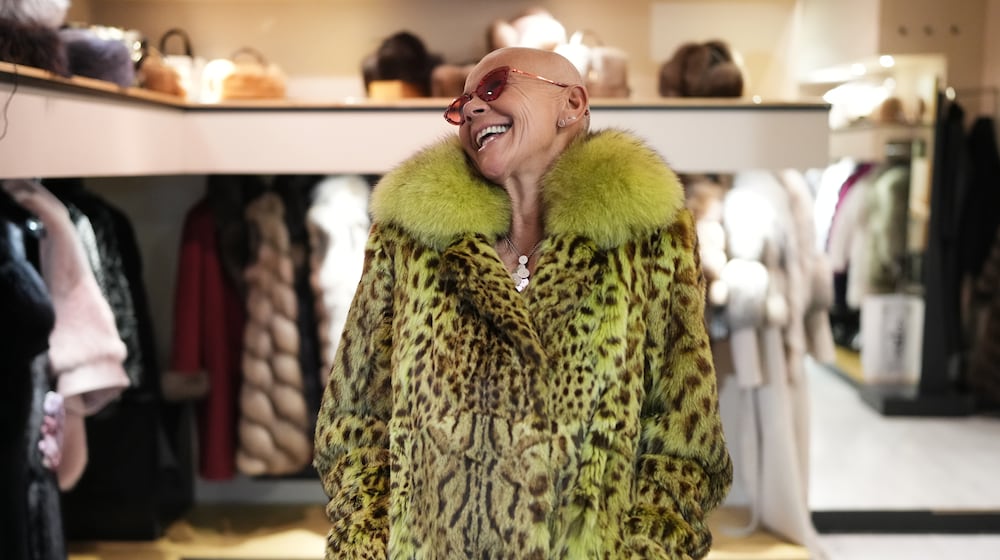 Paola De Leidi poses for a photo wearing a fur coat after an interview with The Associated Press in the Pajaro shop, in Cortina d'Ampezzo, Italy, Saturday, Feb. 14, 2026. (AP Photo/Alessandra Tarantino)