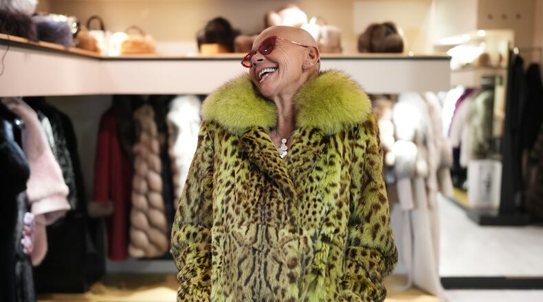 Paola De Leidi poses for a photo wearing a fur coat after an interview with The Associated Press in the Pajaro shop, in Cortina d'Ampezzo, Italy, Saturday, Feb. 14, 2026. (AP Photo/Alessandra Tarantino)