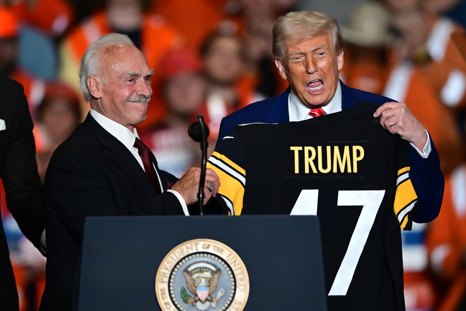 Former Pittsburgh Steelers Rocky Bleier present a Pittsburgh Steelers jersey to President Donald Trump at the U.S. Steel Mon Valley Works-Irvin plant, Friday, May 30, 2025, in West Mifflin, Pa. (AP Photo/David Dermer)