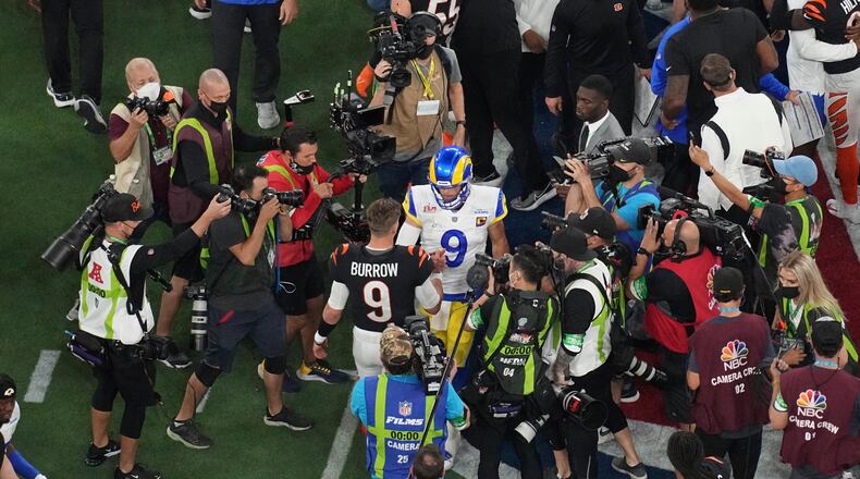 Cincinnati Bengals quarterback Joe Burrow (9) and Los Angeles Rams quarterback Matthew Stafford (9) shake hands at the end of the NFL Super Bowl 56 football game, Sunday, Feb. 13, 2022, in Inglewood, Calif. (AP Photo/Morry Gash)