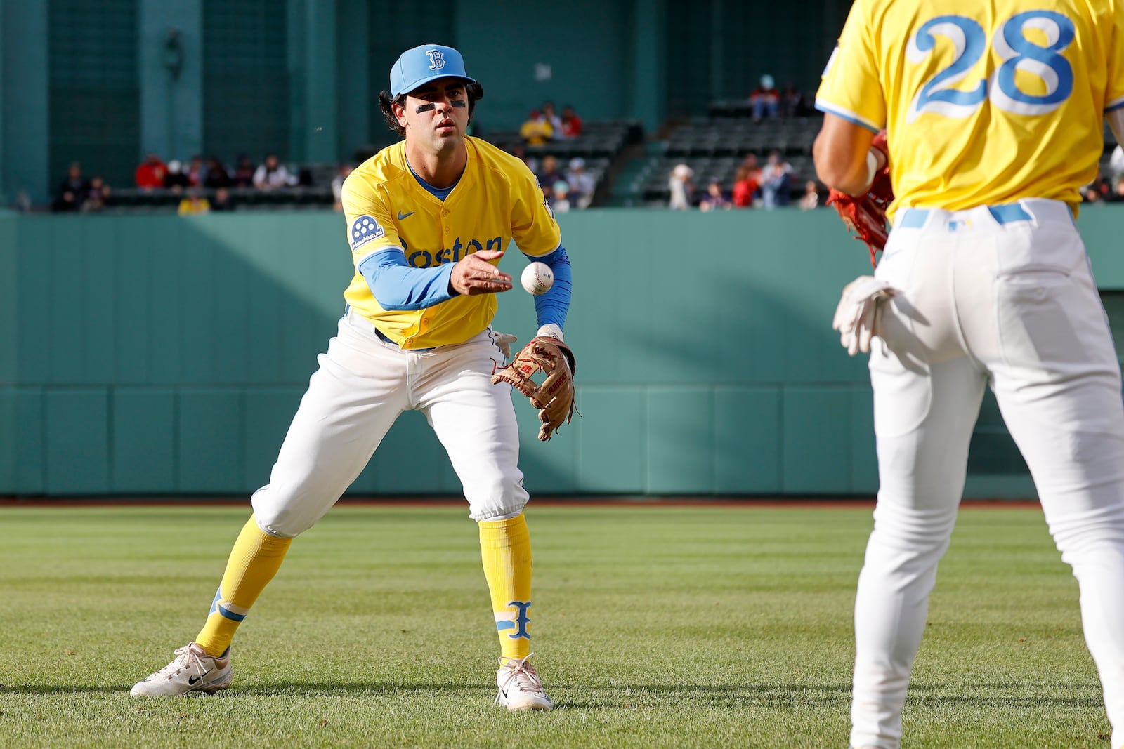 Boston Red Sox third baseman Marcelo Mayer tosses a ball as he warms up before the second baseball game of a doubleheader against the Baltimore Orioles, Saturday, May 24, 2025, at Fenway Park in Boston. (AP Photo/Mary Schwalm)