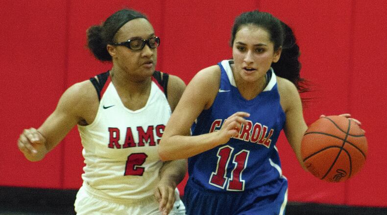 Carroll’s Marina Stevens dribbles up the court in the fourth quarter Tuesday night against Trotwood-Madison’s Myla Barnes. Carroll won 52-41. JEFF GILBERT / CONTRIBUTOR
