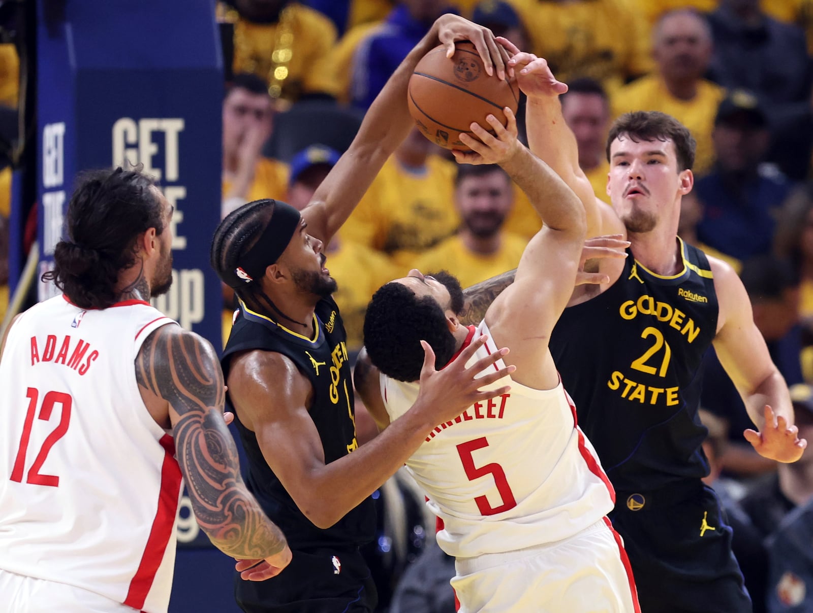 Golden State Warriors' Moses Moody, second from left, and Quinten Post, right, defend against Houston Rockets' Fred VanVleet (5) in the second quarter of Game 6 of an NBA basketball first-round playoff series Friday, May 2, 2025, in San Francisco. A foul was called on the Warriors on the play. (Santiago Mejia/San Francisco Chronicle via AP)