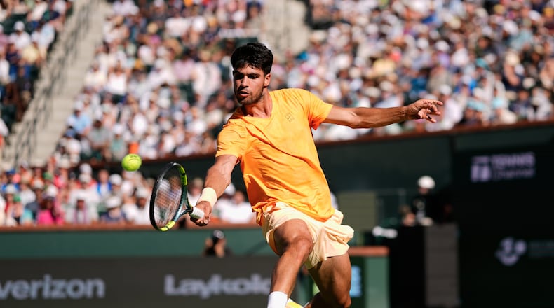 Carlos Alcaraz, of Spain, returns a shot against Daniil Medvedev, of Russia, during a semifinal match at the BNP Paribas Open tennis tournament, Saturday, March 14, 2026, in Indian Wells, Calif. (AP Photo/Mark J. Terrill)