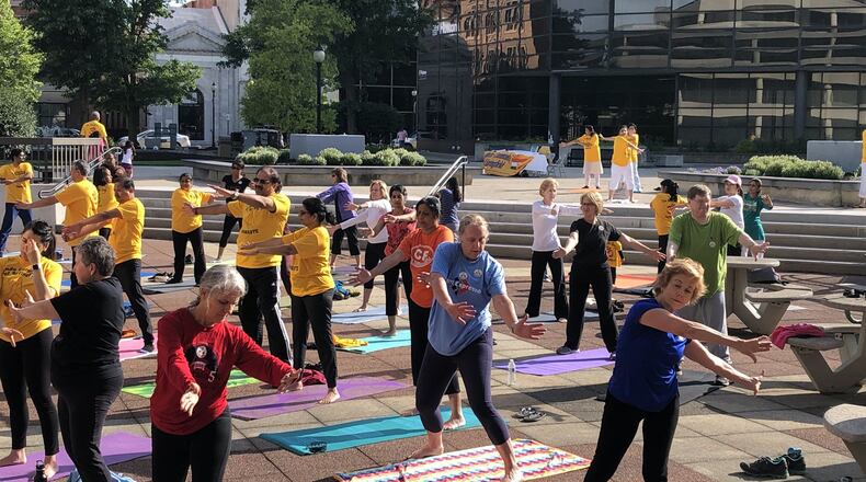Participants practiced various yoga moves under sunny skies at International Yoga Day, presented by the Hindu Community of Springfield and the Global Education and Peace Network. Photo by Brett Turner
