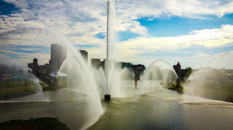 The downtown Dayton skyline is seen through the fountain spray Sept. 3, 2021, at Deeds Point MetroPark on Webster Street. JIM NOELKER/STAFF