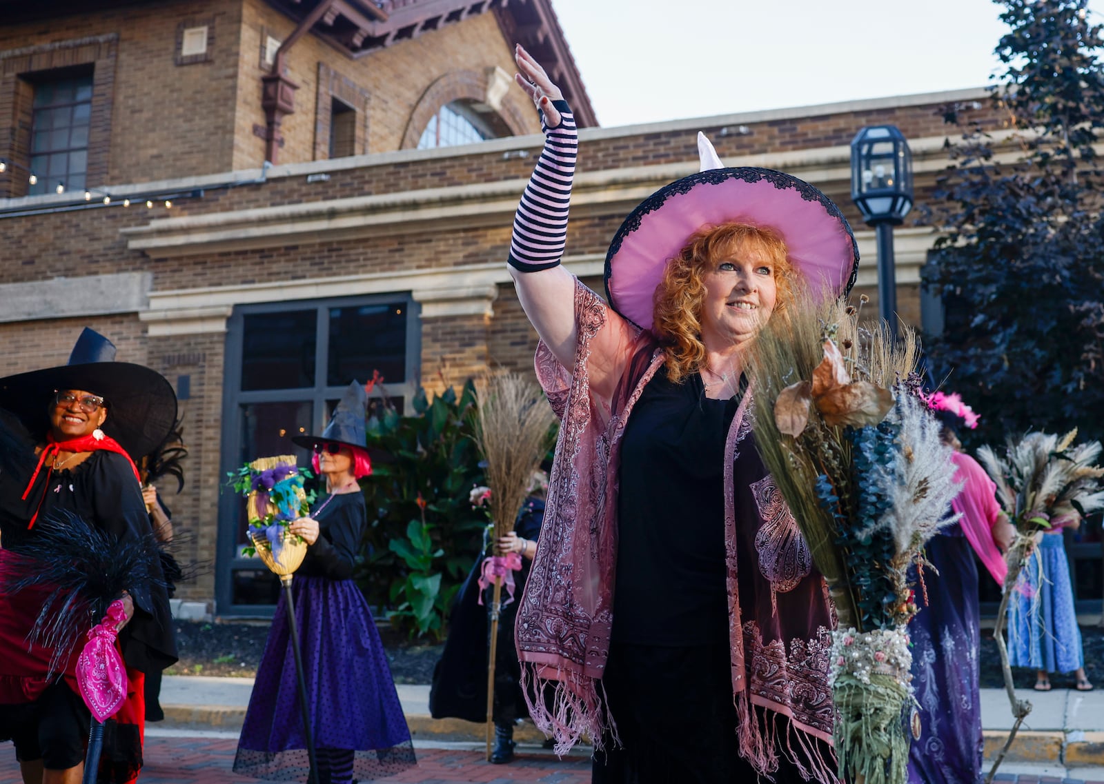 Jodi Ray-Patton, center, dances with the Rose City Witches outside Myers Market on Friday, October 3, 2025, in Springfield. The performance was part of a Think Pink Foundation event to raise awareness about breast cancer. JOSEPH COOKE/STAFF
