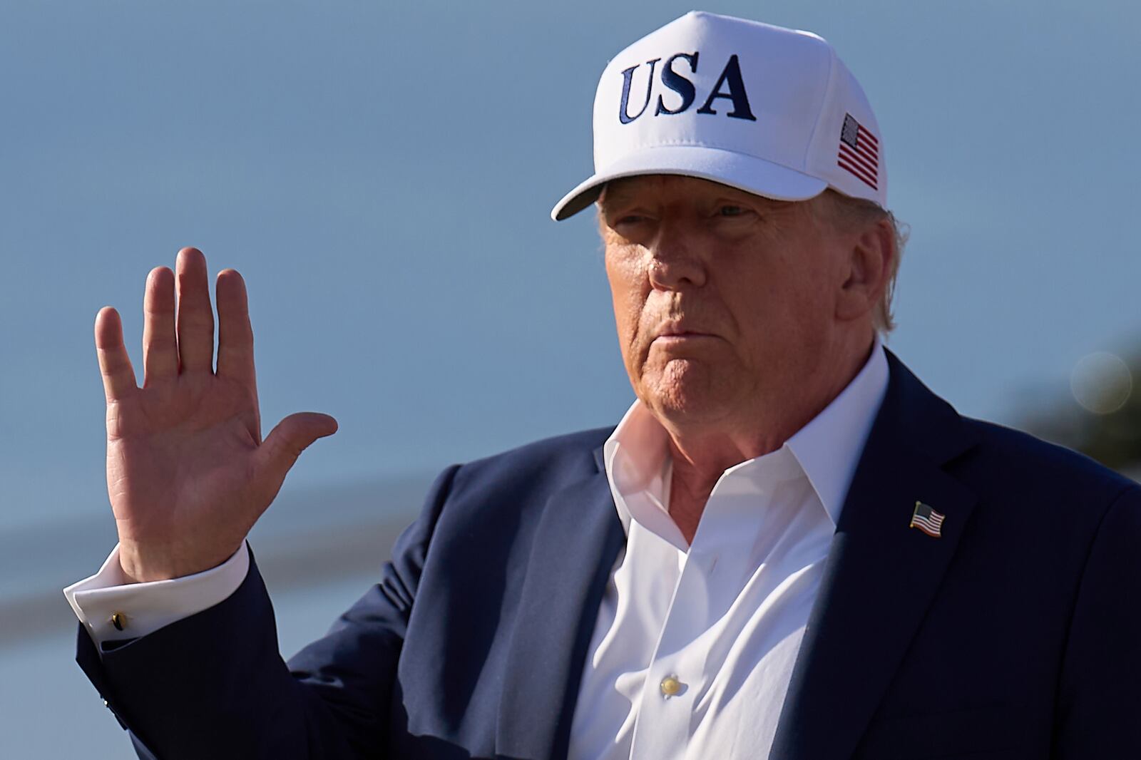 President Donald Trump waves to the media after exiting Air Force One, at Joint Base Andrews, Md., Sunday, July 6, 2025, en route to the White House after spending the weekend in New Jersey. (AP Photo/Jacquelyn Martin)
