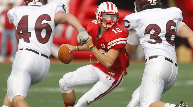 Wittenberg quarterback Reed Florence (12) is pursued by John Marshall (46) and Joe Tripolitakis (36) of Chicago during Saturday’s football game on October 13, 2012 at Edwards-Maurer Field in Springfield. Wittenberg won the game 41-17. Barbara J. Perenic/Springfield News-Sun