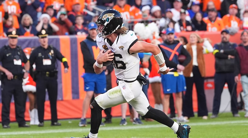 Jacksonville Jaguars quarterback Trevor Lawrence runs for a touchdown against the Denver Broncos during the second half of an NFL football game in Denver, Sunday, Dec. 21, 2025. (AP Photo/David Zalubowski)