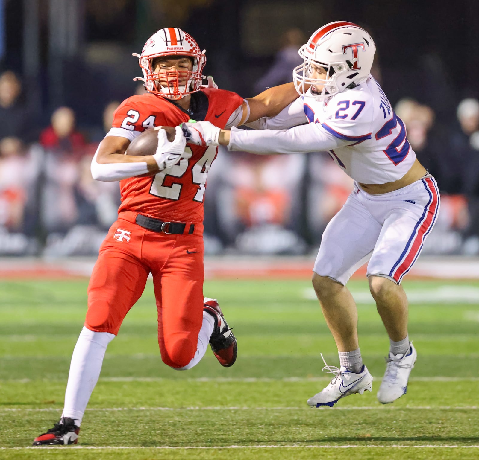 Tippecanoe senior running back Xavier Melton runs with pressure from Talawanda's Kendrick Fox during a Division III, Region 12 quarterfinal on Friday, Nov. 7 at Tipp City Park. Melton scored four TDs in the Red Devils' 55-7 win. BRYANT BILLING/STAFF